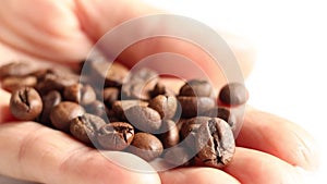 Roasted coffee beans in a girl's hand