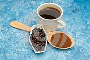 Roasted coffee beans, ground coffee, Cup of coffee, Wooden spoon with roasted coffee
