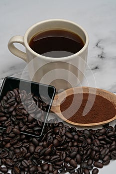 Roasted coffee beans, ground coffee, Cup of coffee, Wooden spoon with roasted coffee