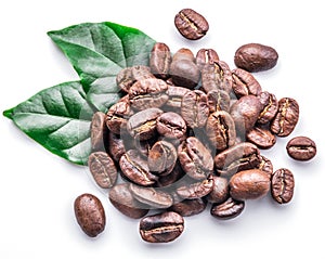 Roasted coffee beans and leaves on white background.