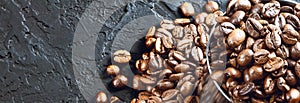 Roasted coffee beans in metal cup on a black background.Copy space. Banner
