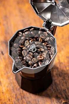 Roasted coffee beans in mocca pot