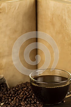 Roasted coffee beans on old vintage open book.