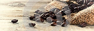 Roasted coffee beans on old wood background