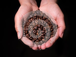 Roasted Coffee Beans overhead view held by woman in cupped hands