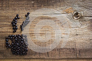 Roasted coffee beans placed in the shape of a cup