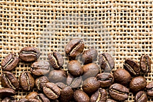 Roasted coffee beans, on sackcloth, closeup image, space for text