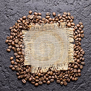 Roasted coffee beans, on sackcloth, closeup image, space for text
