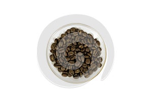 Roasted coffee beans in a saucer on a white background. Isolated on white