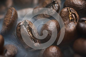 Roasted coffee beans with smoke. Coffee Background photo