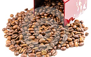 Roasted coffee beans spilling out of a metal box