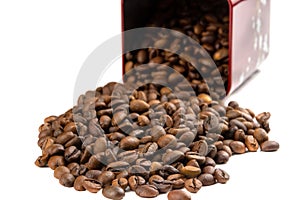 Roasted coffee beans spilling out of a metal box