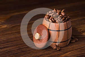 Roasted coffee beans in a wooden barrel