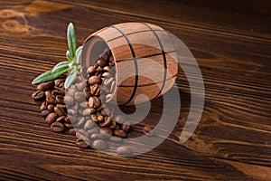 Roasted coffee beans in a wooden barrel