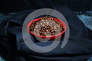 Roasted coffeebeans in a ceramic bowl
