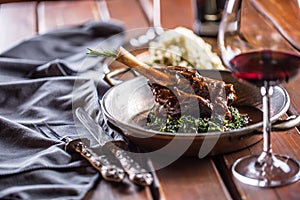 Roasted or confit Lamb Leg in pan with spinach and red wine