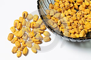 Roasted corn nuts in plate on white background
