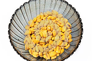 Roasted corn nuts in plate on white background