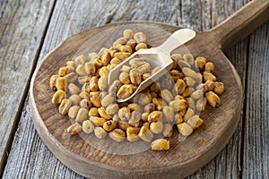 Roasted corn snack. Corn nuts with sauce on wood background