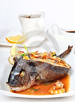 Roasted dorade stuffed with seafood