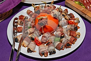 Roasted dried plums wrapped in bacon