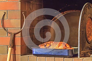 Roasted duck at firewood oven background