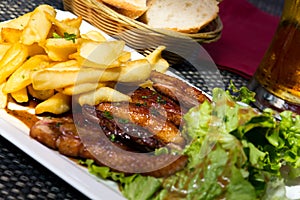 Roasted duck with french fries, potatoes, caramelized, and Salad