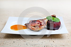 Roasted duck leg baked with apple in red wine