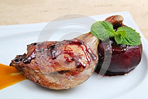 Roasted duck leg baked with apple in red wine