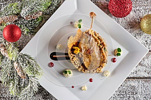 Roasted duck leg with mash and sauce on white plate, christmas traditional food