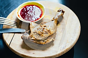 Roasted Duck Leg with Spices, Lemon Juice, Mustard and Berry Sauce on Dark Background