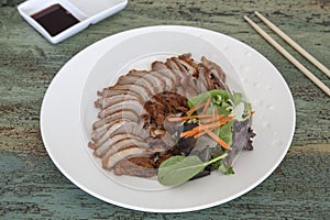 Roasted duck with soy sauce on vintage wooden background, Thai food, Chinese food