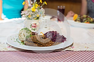 Roasted eisbein or German pork knuckles served on a bed of shredded cabbage