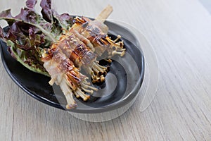 Roasted enoki mushrooms with bacon . Japanese food