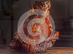 roasted and festering pork knee on a wooden board photo