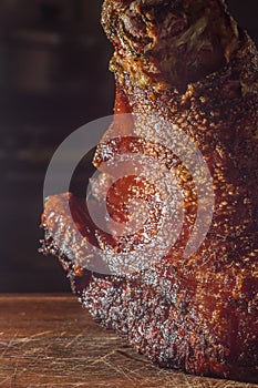 roasted and festering pork knee on a wooden board photo