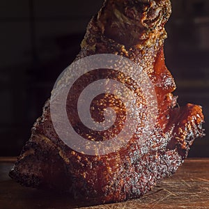 roasted and festering pork knee on a wooden board photo