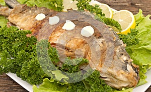 Roasted fish with fresh herbs and lemon. Selective focus