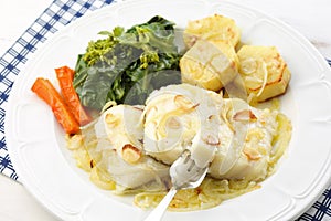 Roasted fresh cod fillet with cabbage and potatoes