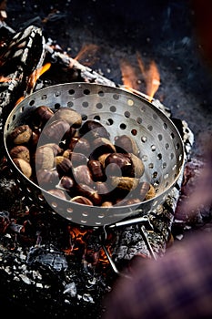 Roasted fresh sweet chestnuts on hot coals