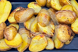 Roasted golden potatoes, halved and seasoned, displayed at a casual dining setting