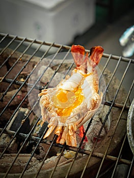 Roasted grilled fresh giant river prawn burn flaming on charcoal stove.