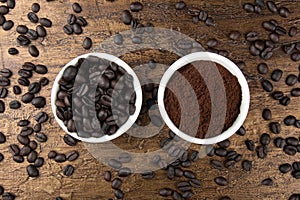 Roasted and ground coffee beans in white bowl. Rustic background