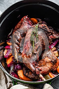 Roasted hare Haunches in stewpot with Stewed  Vegetables. Cooking stew. Top view