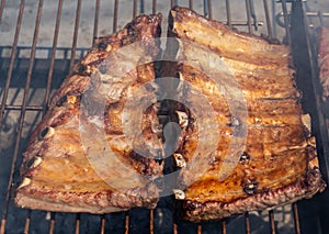 Roasted Juicy spare ribs cooked over the coals on a barbecue. Summer and holiday time