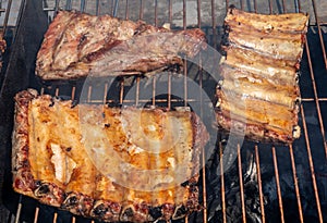 Roasted Juicy spare ribs cooked over the coals on a barbecue. Summer and holiday time