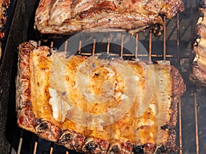 Roasted Juicy spare ribs cooked over the coals on a barbecue. Summer and holiday time