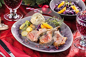 Roasted lamb or venison ribs on christmas table fetive dekoration food