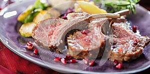 Roasted lamb or venison ribs on christmas table fetive dekoration food