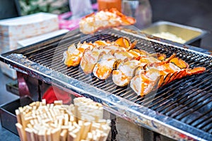 Roasted lobster with cheese at Myeong-dong street food in Seoul, South Korea photo